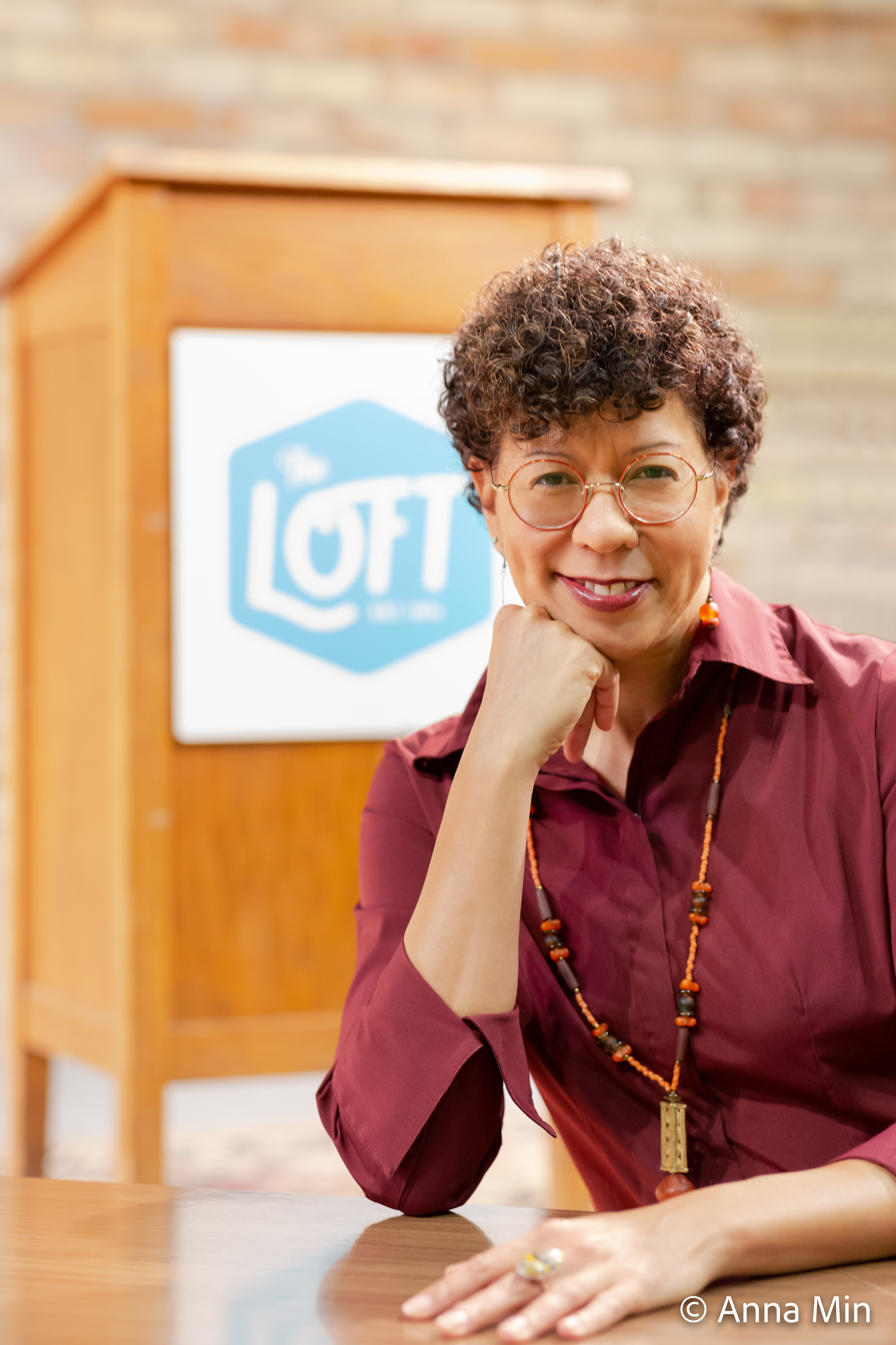 Photo of executive Arleta Little in front of podium with Loft logo